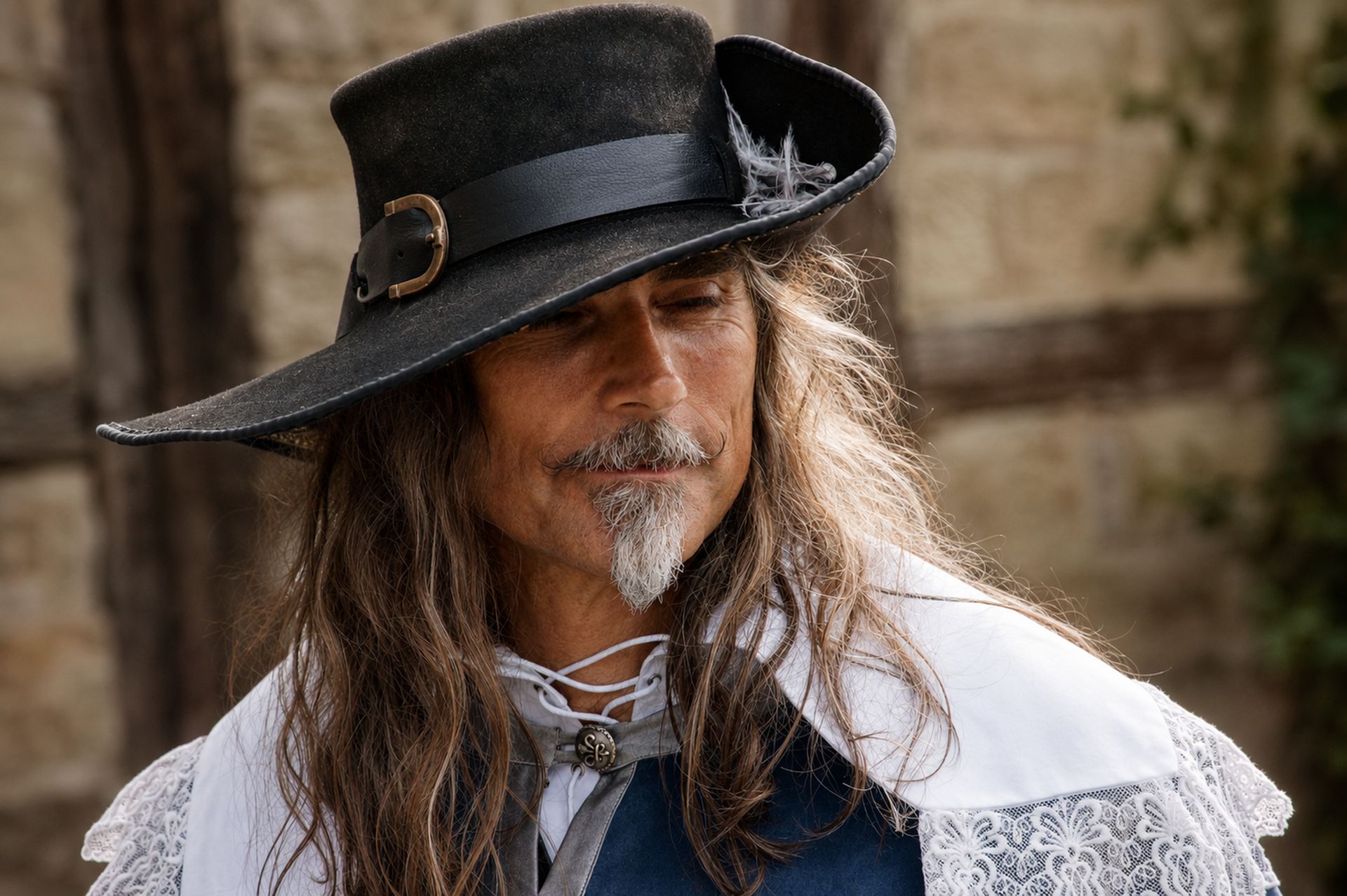 Mousquetaire au regard méditatif sous un chapeau noir